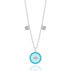 The Evil Eye Pendant Necklace by Vellura Jewellery features a sterling silver chain with two clear gemstones and a round turquoise pendant with a diamond-shaped design, combining spiritual symbolism and vibrant elegance.