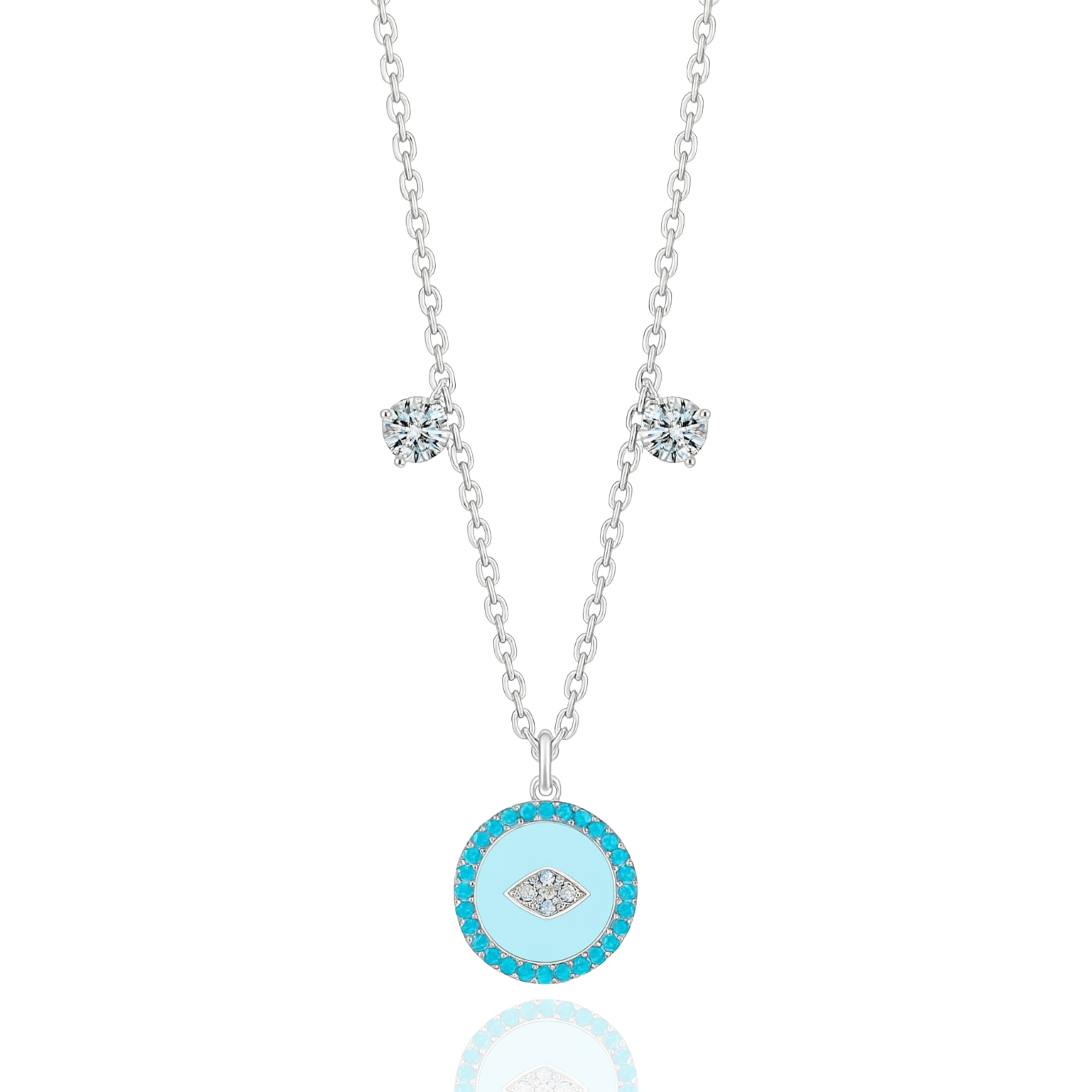 The Evil Eye Pendant Necklace by Vellura Jewellery features a sterling silver chain with two clear gemstones and a round turquoise pendant with a diamond-shaped design, combining spiritual symbolism and vibrant elegance.